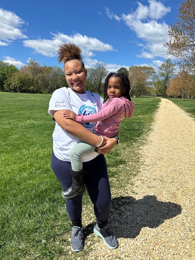 Mother holding daughter during their walk for sjogrens